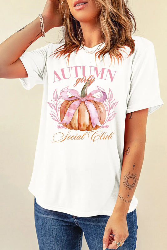 Person wearing a white t-shirt with an autumn-themed graphic design.