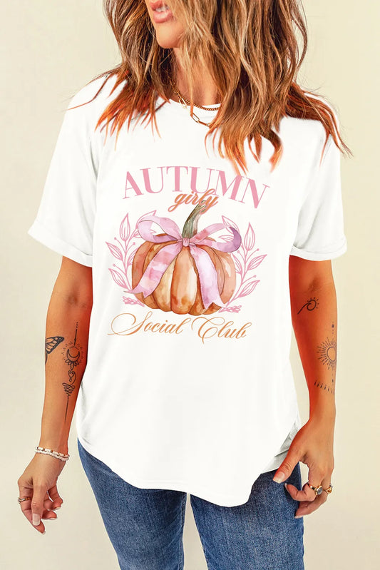 Person wearing a white t-shirt with an autumn-themed design on a beige background