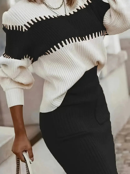 Person wearing a black and white sweater with a blurred background