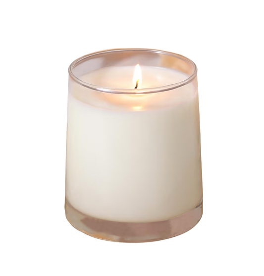 White candle in a glass holder on a white background
