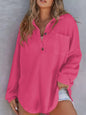 Woman wearing a pink textured shirt against a gray background