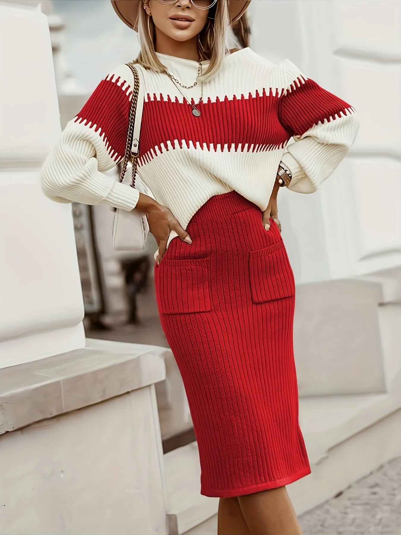 Woman wearing a red and white sweater with a red skirt outdoors.