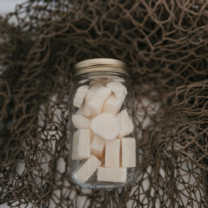 Jar of white cubes on a textured brown background