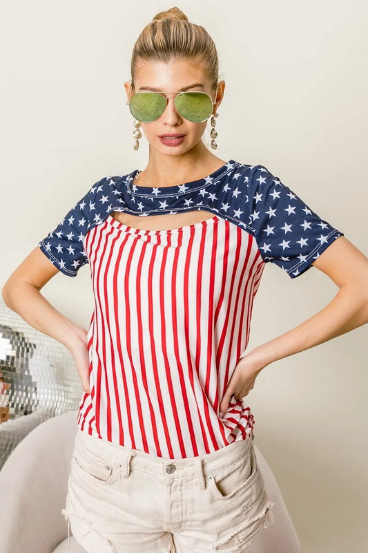 The American Flag Theme Front Cut Out Top showcases patriotic flair with its American flag theme design. The front cut-out detail adds a trendy and edgy touch to the top, showcasing the stars across the shoulders and the strips down the torso.