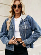 Woman wearing a denim jacket over a white top with a neutral background