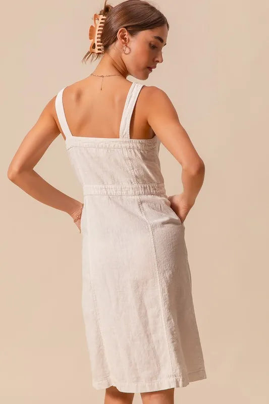 The Button Down Pocket Front Pinafore Dress is a stylish and versatile piece for your wardrobe. With a button-down front and pocket detailing, this pinafore dress offers a classic and chic look.
