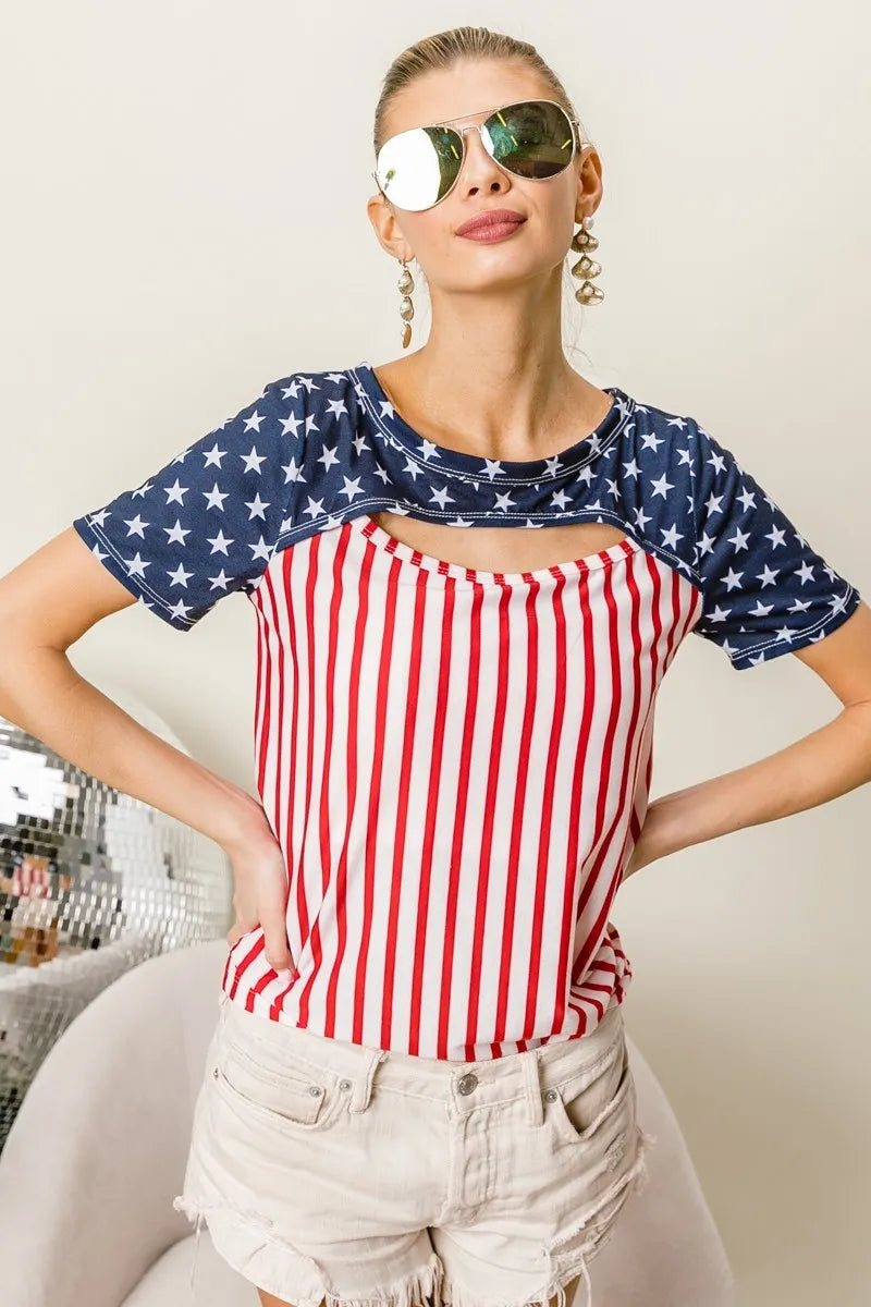 The American Flag Theme Front Cut Out Top showcases patriotic flair with its American flag theme design. The front cut-out detail adds a trendy and edgy touch to the top, showcasing the stars across the shoulders and the strips down the torso.