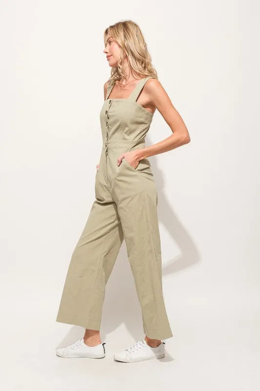 The Square Neck Button Down Cropped Wide-leg Sage Jumpsuit is a stylish and versatile one-piece outfit with a square neckline, button-down front, and wide-leg cropped pants.