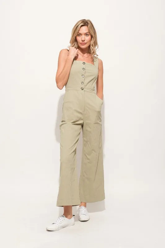 The Square Neck Button Down Cropped Wide-leg Sage Jumpsuit is a stylish and versatile one-piece outfit with a square neckline, button-down front, and wide-leg cropped pants.