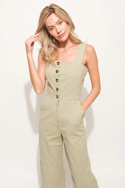 The Square Neck Button Down Cropped Wide-leg Sage Jumpsuit is a stylish and versatile one-piece outfit with a square neckline, button-down front, and wide-leg cropped pants.