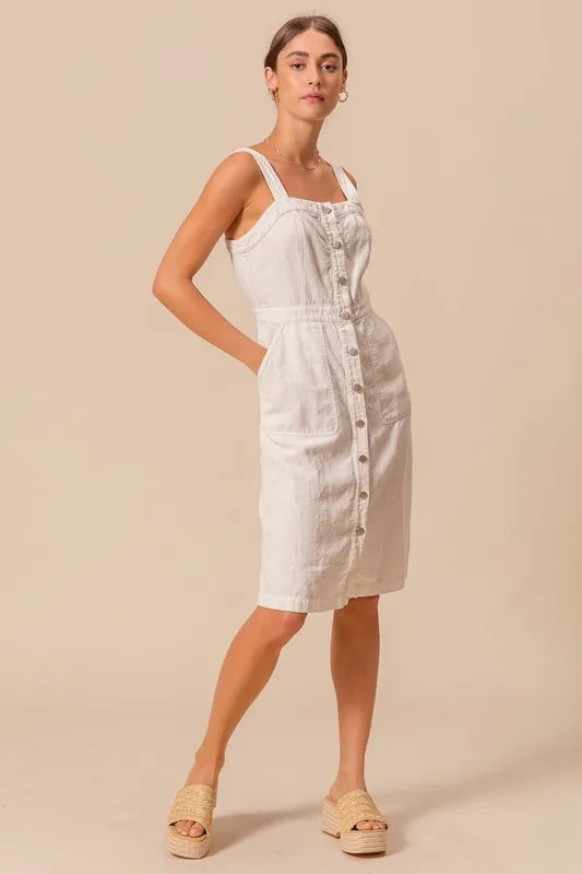 The Button Down Pocket Front Pinafore Dress is a stylish and versatile piece for your wardrobe. With a button-down front and pocket detailing, this pinafore dress offers a classic and chic look.