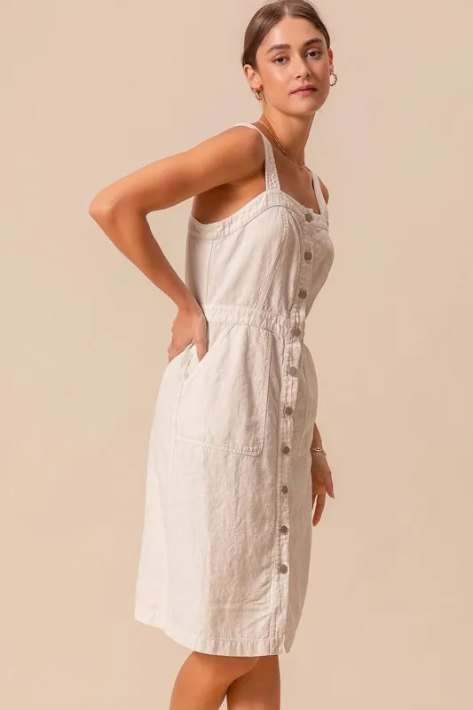 The Button Down Pocket Front Pinafore Dress is a stylish and versatile piece for your wardrobe. With a button-down front and pocket detailing, this pinafore dress offers a classic and chic look.