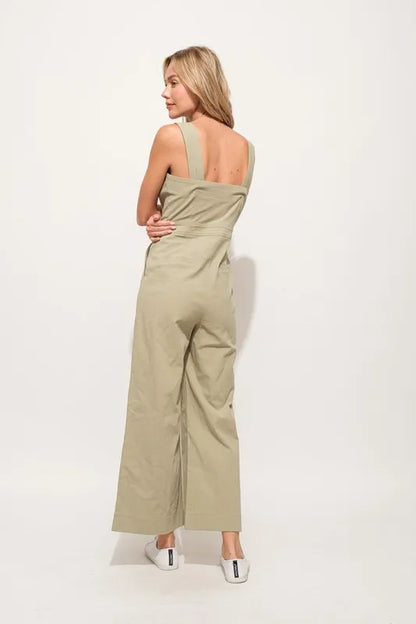 The Square Neck Button Down Cropped Wide-leg Sage Jumpsuit is a stylish and versatile one-piece outfit with a square neckline, button-down front, and wide-leg cropped pants.